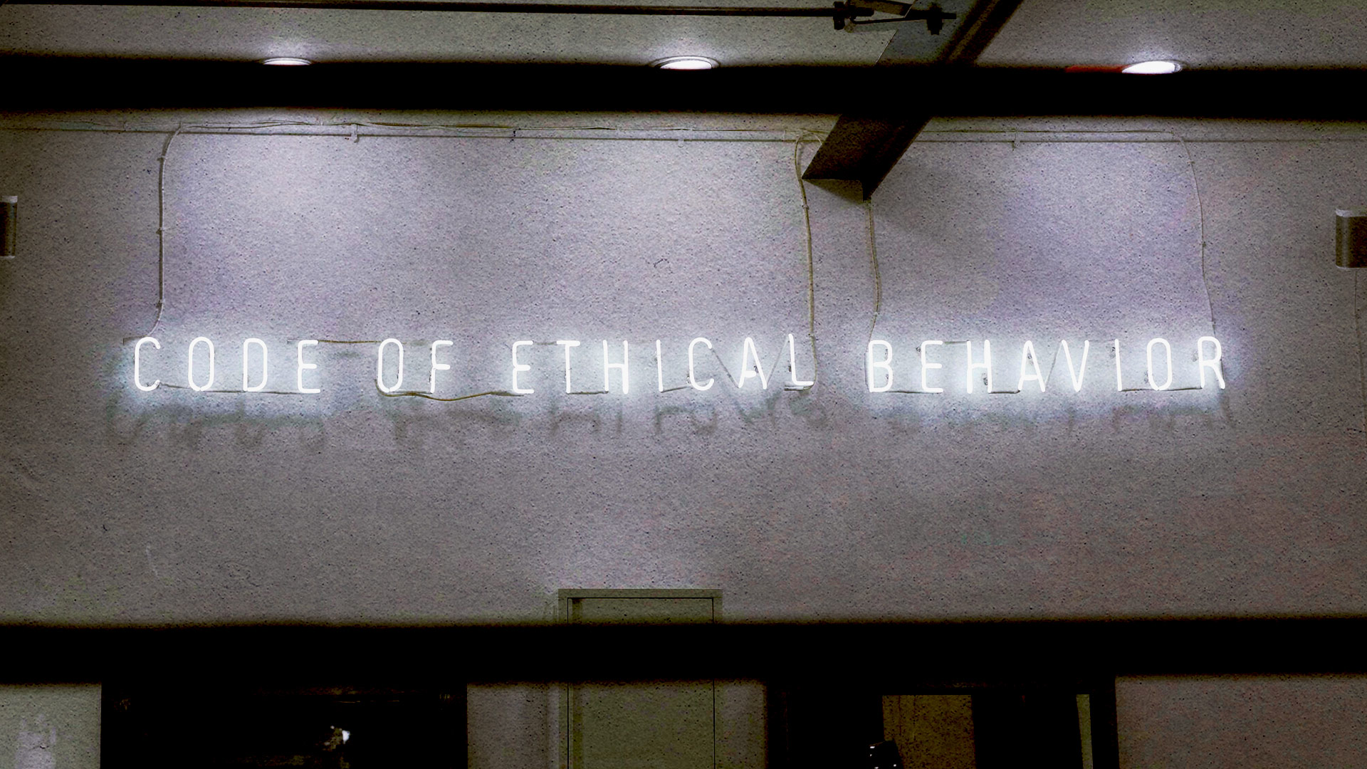 Neon sign reading Code Of Ethical Behaviour supporting notion of ethical braning and marketing